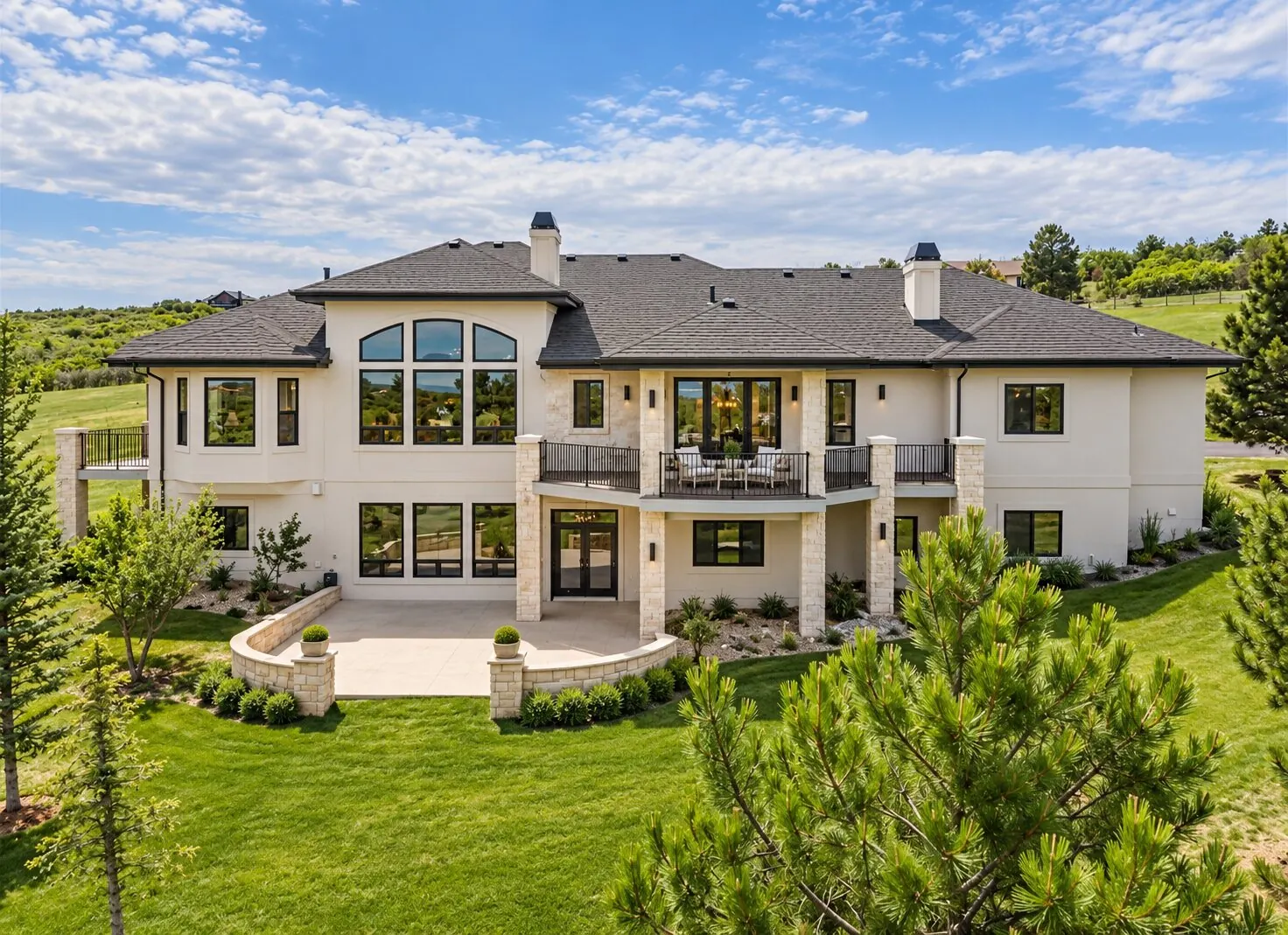 Two-story custom home with stone columns and covered balcony